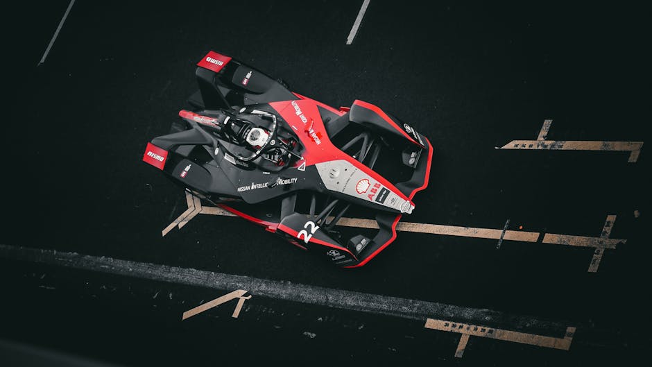 Aerial view of a racing car on a track showcasing speed and design.
